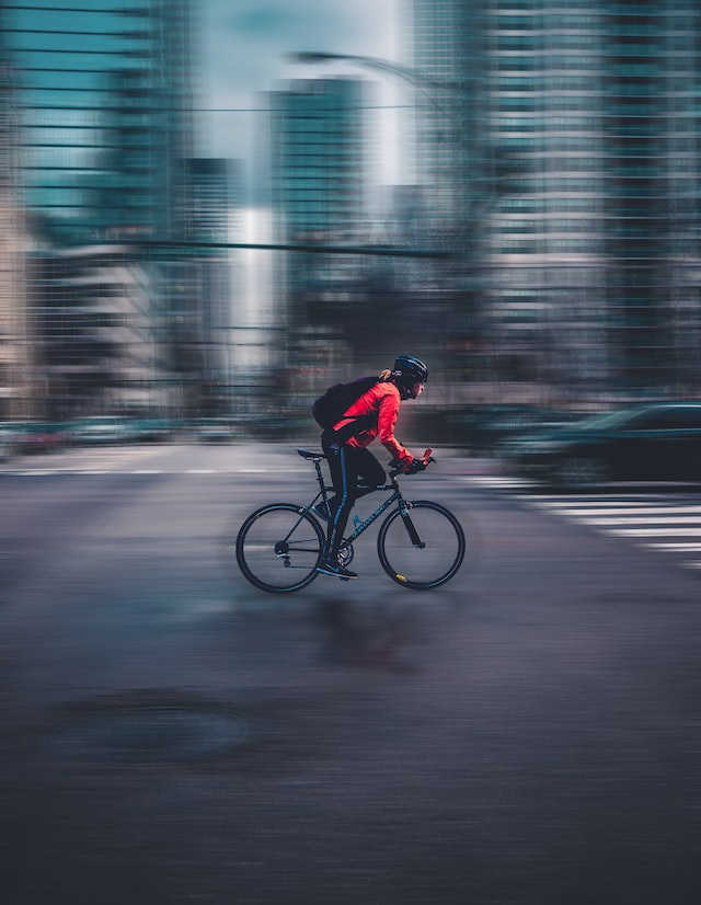 man cycling fast in the city